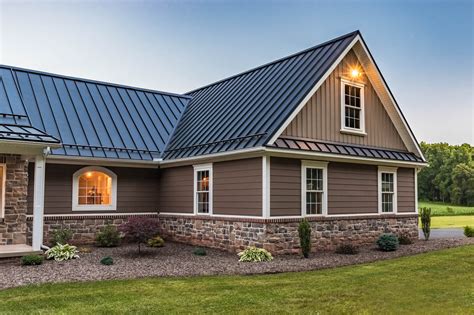 brick and stone house with metal roof|homes with brown metal roofs.